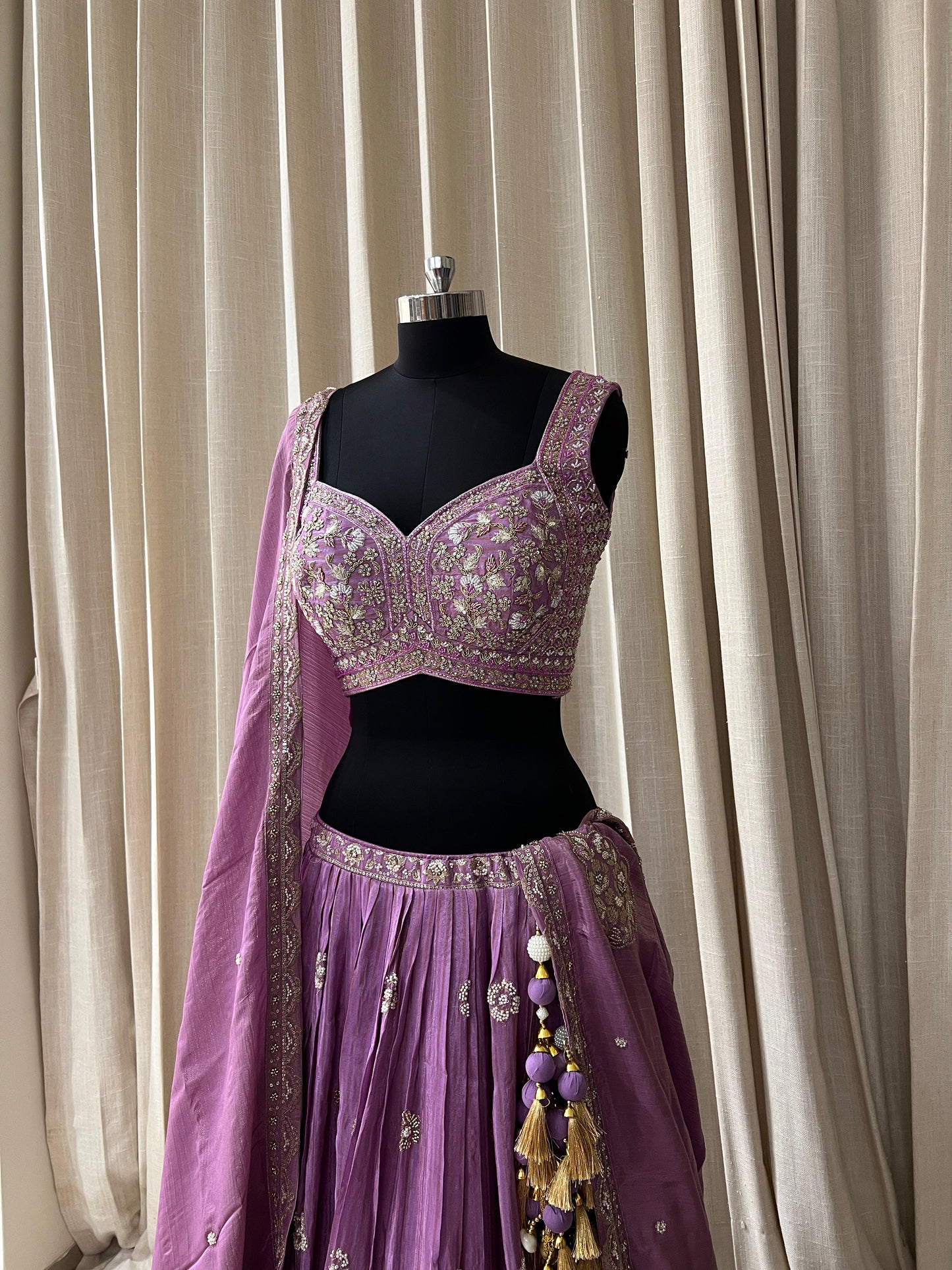 Lavender Embroidered Lehenga Choli with Mirror and Tassel Detailing Description: