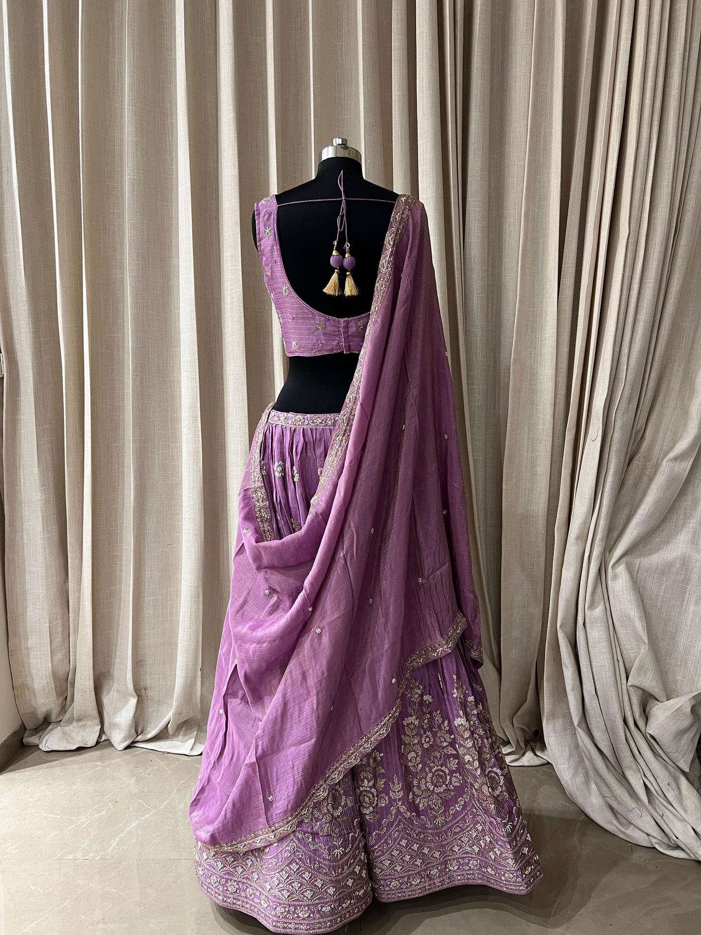 Lavender Embroidered Lehenga Choli with Mirror and Tassel Detailing Description:
