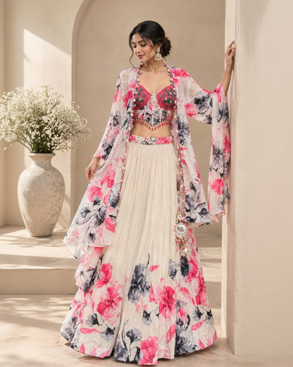Ivory Floral Printed Lehenga Choli Set with Pink & Black Flowers, Embellished Crop Top, Shrug & Tassel Details | Festive Wear
